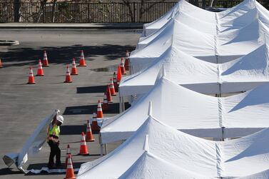 A worker helps construct a large scale Covid-19 Federal Emergency Management Agency vaccination site at Cal State Los Angeles on February 12, 2021 in Los Angeles, California. AFP