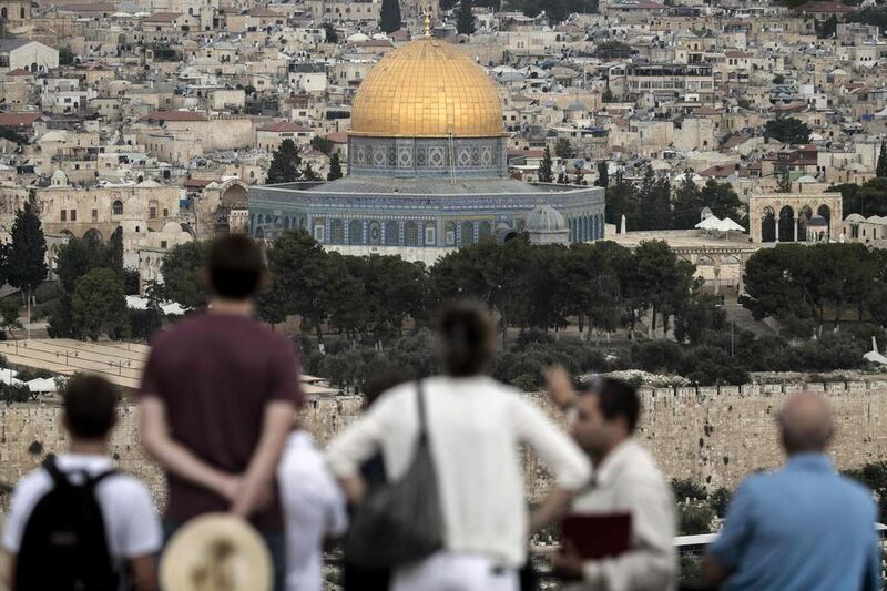 Tourists visit the Mount of Olives in East Jerusalem, overlooking the Old City and the Dome of the Rock at the Al Aqsa Mosque compound. AFP