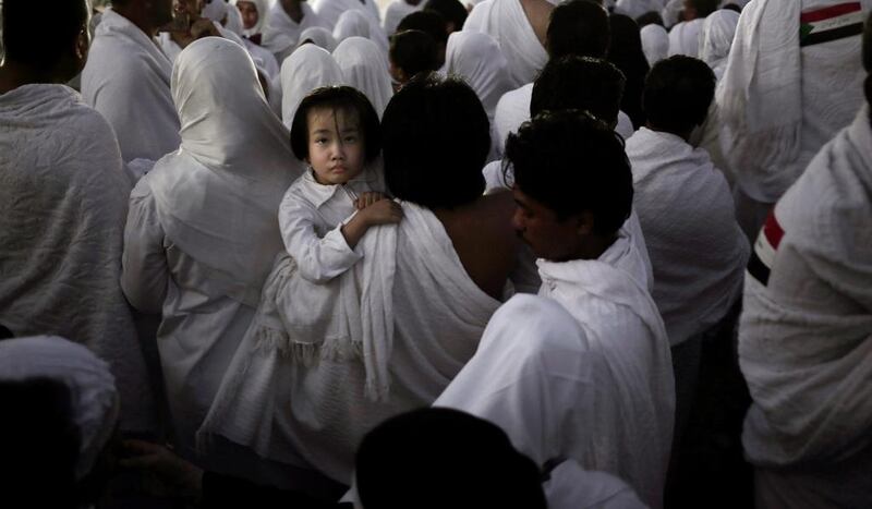 An Indonesian father carries his daughter through the crowd after reaching the top of the Mountain of Mercy, on the Plain of Arafat, during the annual hajj pilgrimage, ahead of sunrise near the holy city of Mecca, Saudi Arabia.  Nariman El-Mofty / AP Photo