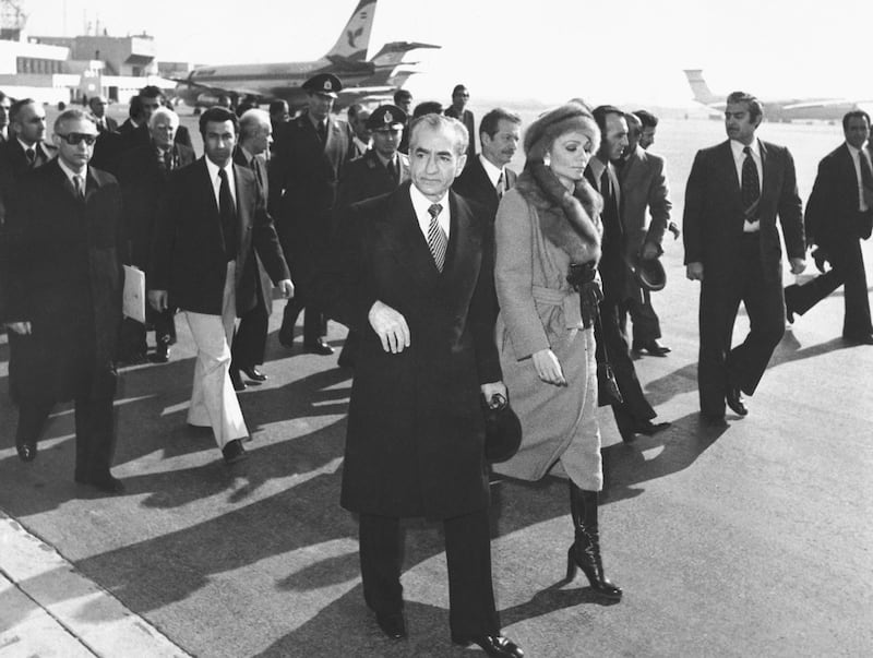 Shah Mohammad Reza Pahlavi and Empress Farah walk on the tarmac at Mehrabad Airport in Tehran, Iran, in January 1979 as they prepare to leave the country after being overthrown. AP
