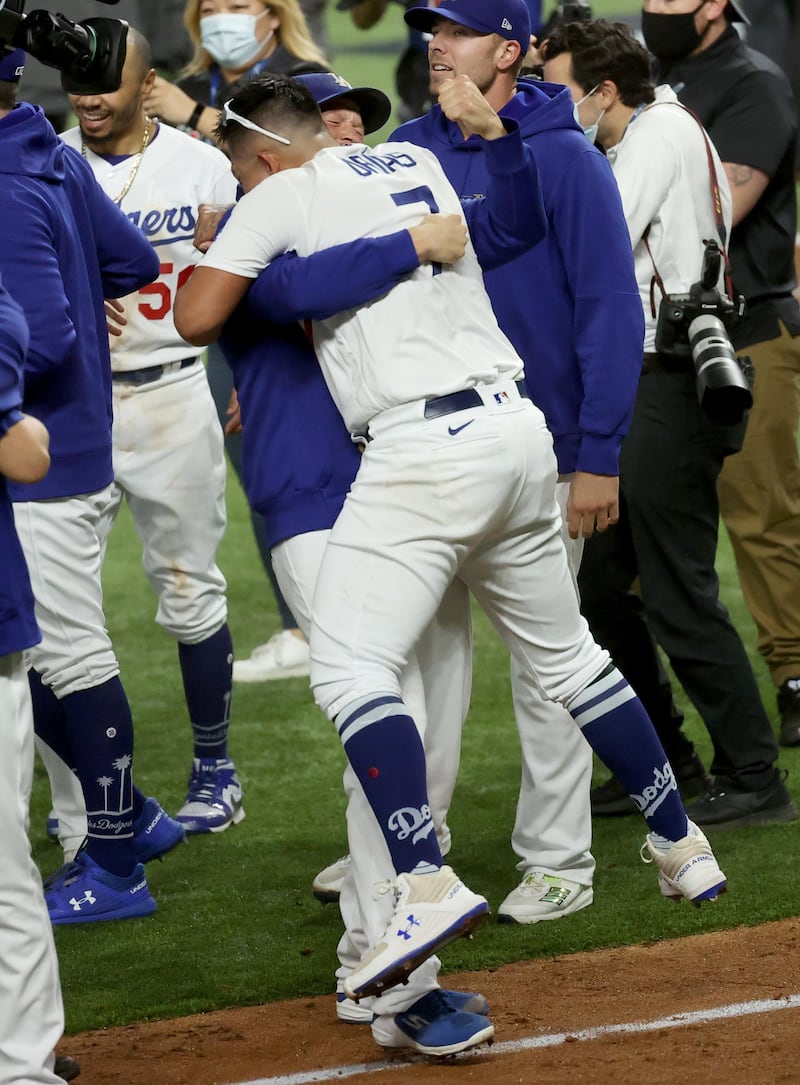 Los Angeles Dodgers pitcher Clayton Kershaw hugs starting pitcher Julio Urias (7) after winning the World Series against the Tampa Bay Rays. USA Today
