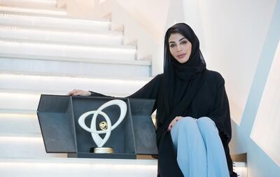 Emirati artist Ashwaq Abdulla with the trophy she designed for the Mubadala Silicon Valley Classic (MSVC). Courtesy of Mubadala