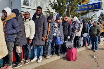 Foreigners wait to go to Poland at the Shegyni Ukrainian border post on March 1, 2022. AFP