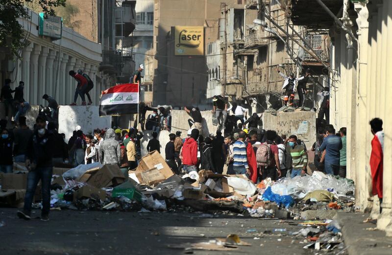 Protesters gather while security forces block Rasheed Street during clashes. AP Photo