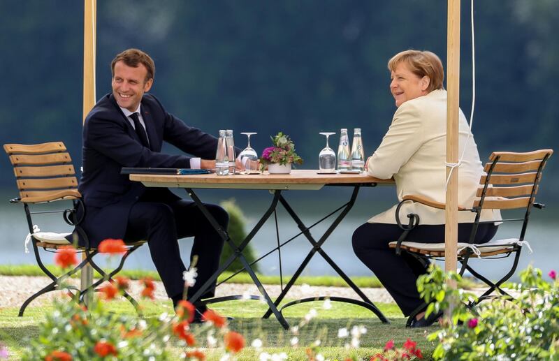 German Chancellor Angela Merkel and French President Emmanuel Macron talk during a bilateral meeting at the German government's guest house Meseberg Castle in Gransee near Berlin, Germany.  EPA