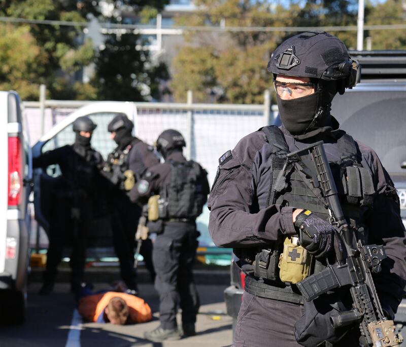 Australian police officers arrest a man, bottom left, during a police operation in Mascot, Sydney in connection to the drug gang operating in Syndey, .  NSW Police / EPA