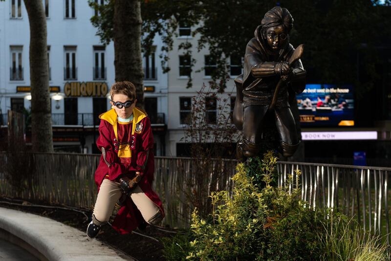 The bronze statue depicts the boy wizard hovering on his broom, the Nimbus 2000, about to launch into a game of quidditch. Getty Images