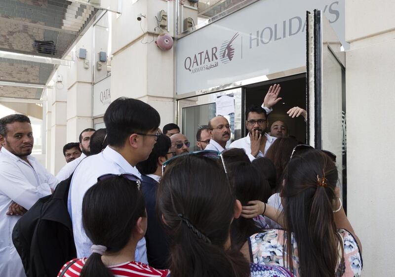 Passangers with flights book on Qatar Airways queue at the airline's Dubai office. Duncan Chard / National
