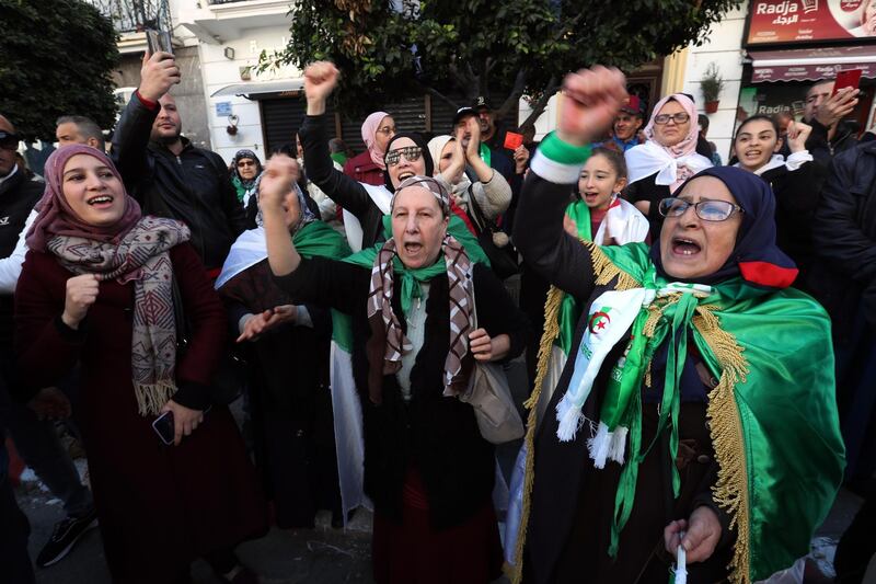 Algerians shout slogans as they march to mark the first anniversary of the popular protests in Algiers.  EPA