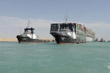 A picture released by Egypt's Suez Canal Authority on March 29, 2021, shows a tugboat pulling the Panama-flagged MV 'Ever Given' container ship after it was fully dislodged from the banks of the Suez. AFP/ Suez Canal Authority 