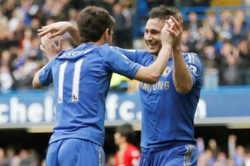 Chelsea’s Oscar, left, celebrates his goal with teammate Frank Lampard during a 2-0 win over Swansea City on Sunday. Sang Tand / AP Photo