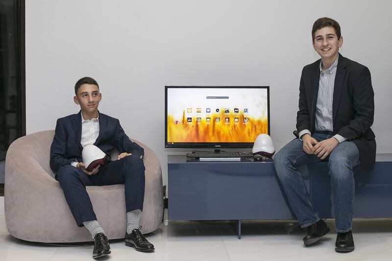 Emirati cousins Abdullah and Marwan are helping to promote a new computer aimed at poorer communities that have little or no access to the internet and technology. Mona Al Marzooqi / The National