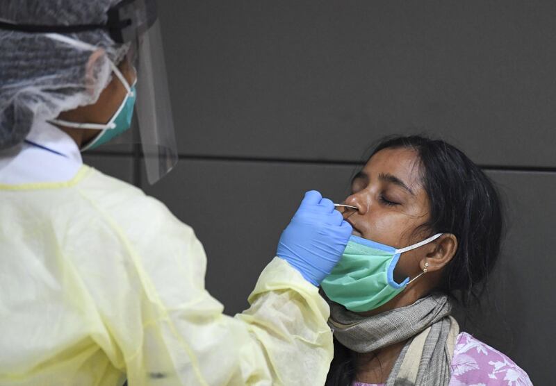 A member of an Indian medical team is tested upon the team's arrival at Dubai International Airport to help with the coronavirus (COVID-19) pandemic.  AFP