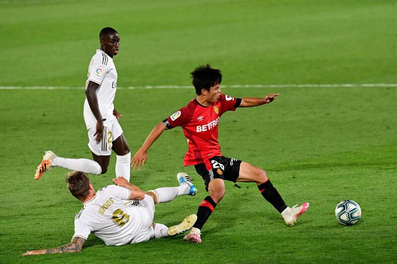 Real Madrid's German midfielder Toni Kroos challenges Real Mallorca's Japanese midfielder Takefusa Kubo. AFP