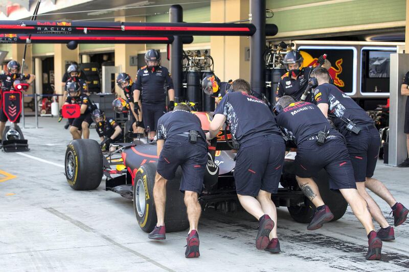 Abu Dhabi, United Arab Emirates, November 24, 2017:    Crew members push Max Verstappen of Belgium and Red Bull Racing car in the pits during practise for the Abu Dhabi Formula One Grand Prix at Yas Marina Circuit in Abu Dhabi on November 24, 2017. Christopher Pike / The National

Reporter: Graham Caygill
Section: Sport