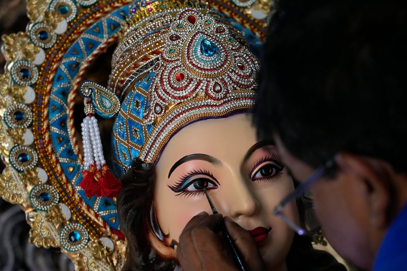 An artist works on an idol of Durga in Mumbai. AP