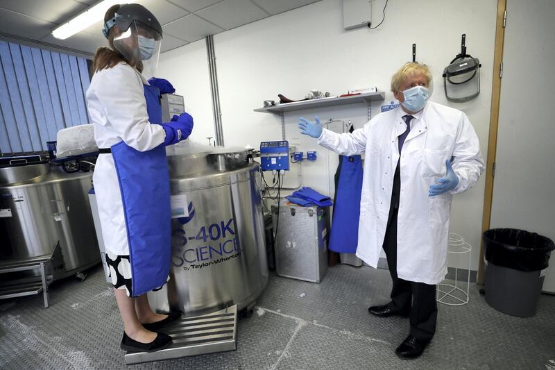 OXFORD, ENGLAND - SEPTEMBER 18: Britain's Prime Minister, Boris Johnson is shown samples stored in liquid nitrogen by Professor Kate Ewer during a visit to the Jenner Institute on September 18, 2020 in Oxford, England. The Prime Minister toured the laboratory and met scientists who are leading the COVID-19 vaccine research. (Photo by Kirsty Wigglesworth - WPA Pool/Getty Images)