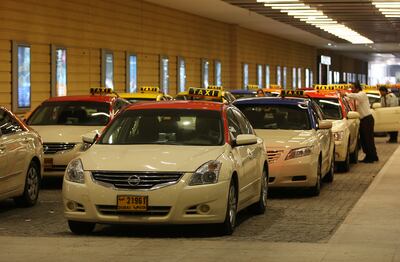 DUBAI , UNITED ARAB EMIRATES Ð Feb 22 : RTA taxi parked in the taxi pick up area in Dubai Mall in Dubai. ( Pawan Singh / The National ) For News



