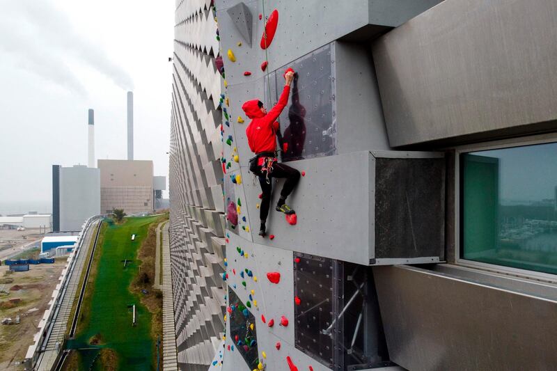 Danish climber Mikkel Frederiksen are on the 85m long climbing wall at the outdoor structure CopenHill in Copenhagen on December 6, 2020. CopenHill is an urban mountain placed on top af a state-of-the-art waste-to energy plant, ARC, which is one of the most unique architectural designs in the world. The plant produces environmental-friendly energy with the newest technology by burning waste and turning the exhaust into energy which yearly provides the city of Copenhagen with electricity for 30,000 households and central heating for 72,000 households.
The structure has a ski hill, a hiking track and a climbing wall. / AFP / Olivier MORIN