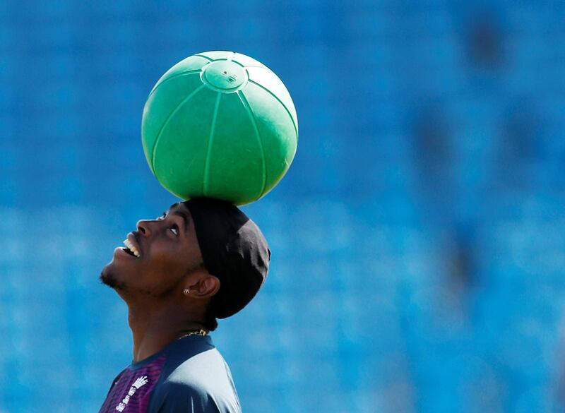 England's Jofra Archer balances a ball on his head. Reuters