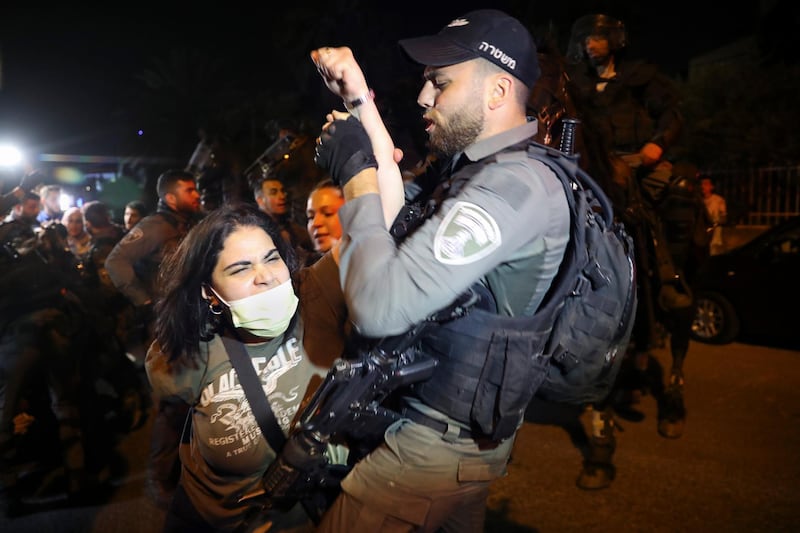 A Palestinian woman and an Israeli policeman scuffle during a protest against the planned evictions of Palestinian families from the Sheikh Jarrah neighborhood of East Jerusalem. AP