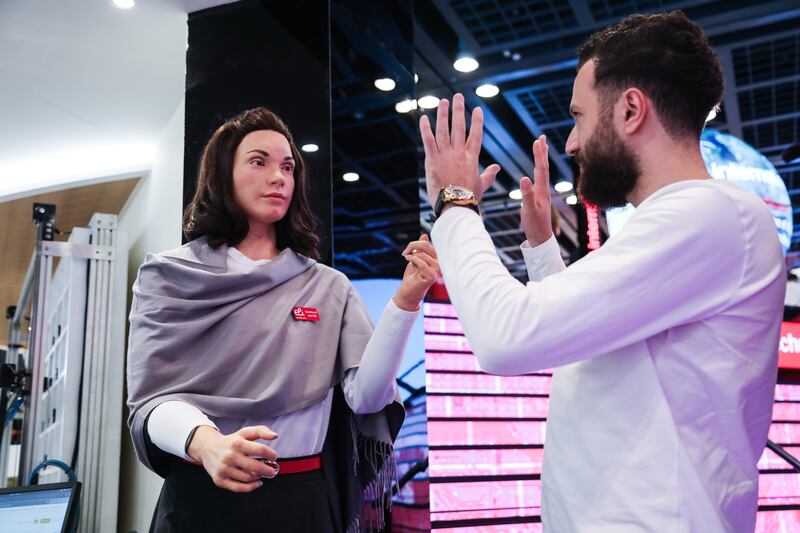 Amina, a robot, interacting with a visitor to the show