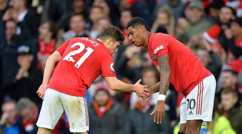 Manchester United's Marcus Rashford celebrates with Harry Maguire. EPA