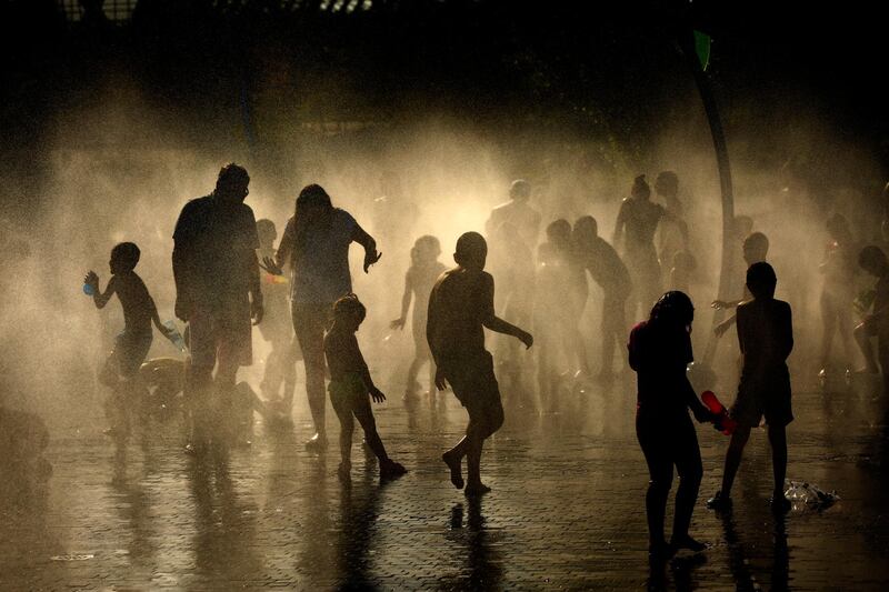 People cool off in an urban beach at Madrid Rio park in Madrid. AP