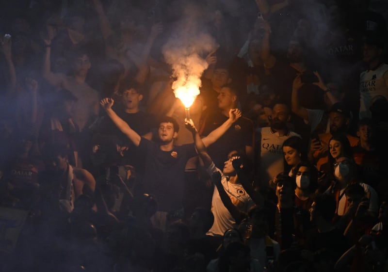 AS Roma fans celebrate with flares after they score their first goal. Reuters