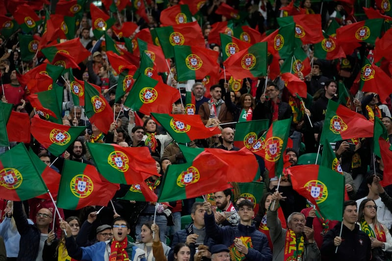 Portuguese fans wave their national flag during a friendly match between Portugal and Nigeria, in Lisbon. The red and green design of the Portuguese flag is similar to that of the Social Democratic Party of India. AP