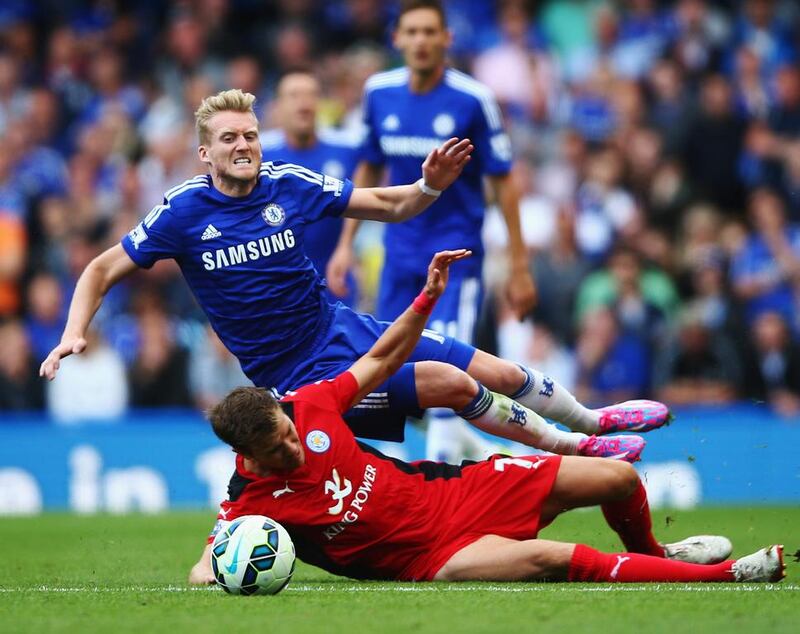 Andre Schurrle of Chelsea is tackled by Dean Hammond of Leicester City and receives a yellow card for the challenge during the Barclays Premier League match between Chelsea and Leicester City at Stamford Bridge on August 23, 2014 in London, England. (Photo by Paul Gilham/Getty Images)