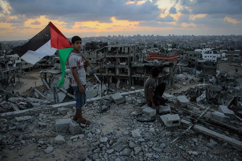 Gazan children look at what remains of their home after Israel launched Operation Protective Edge last summer, in which more than 2,000 Palestinians were killed. Rex Shutterstock / DDP



