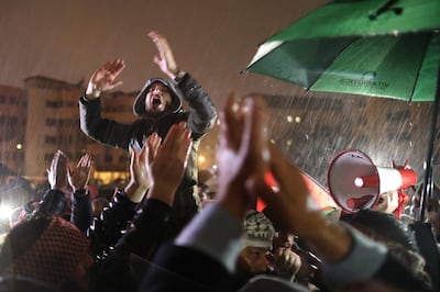 epa07213195 Jordanians shout slogans as they demand the government for reforms in various fields during a protest under a heavy rain, in Amman, Jordan, 06 December 2018. A few hundred protesters gathered in the area leading to the Prime Minister office in central Amman, to demand political and economic reforms. The last time such protests took place, earlier in the summer, they had led to a change of government.  EPA/ANDRE PAIN
