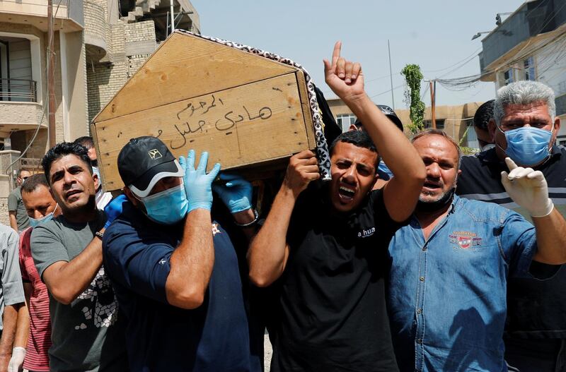 Mourners carry Husham Al Hishami's coffin during the funeral in Baghdad, Iraq. Reuters