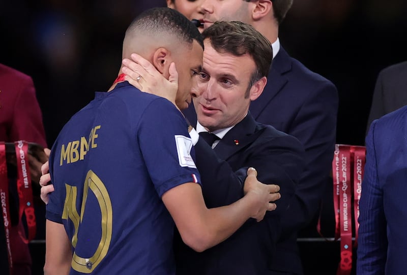 French President Emmanuel Macron with Kylian Mbappe after the World Cup final at the Lusail Stadium in Qatar. EPA