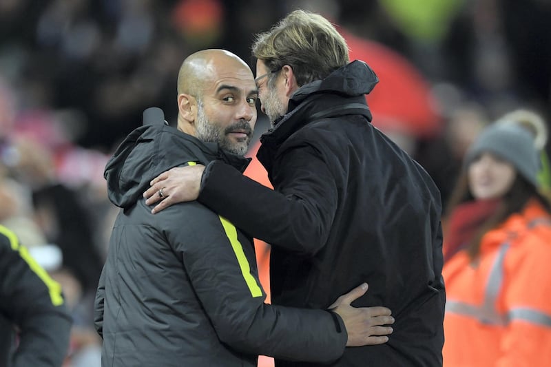Liverpool's German manager Jurgen Klopp (R) greets Manchester City's Spanish manager Pep Guardiola ahead of the English Premier League football match between Liverpool and Manchester City at Anfield in Liverpool, north west England on December 31, 2016. (Photo by Paul ELLIS / AFP) / RESTRICTED TO EDITORIAL USE. No use with unauthorized audio, video, data, fixture lists, club/league logos or 'live' services. Online in-match use limited to 75 images, no video emulation. No use in betting, games or single club/league/player publications. / 