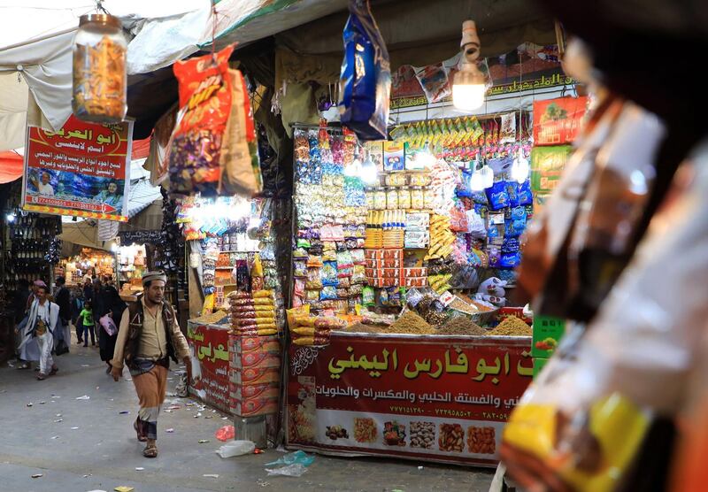 A Yemeni man walks in front of a shop at a market in the capital Sanaa's old quarter.   AFP