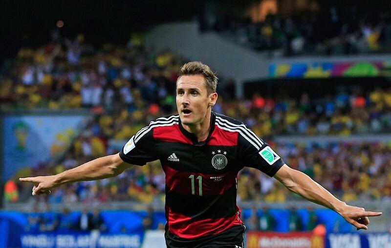 Germany's forward Miroslav Klose celebrates after scoring during the semi-final football match between Brazil and Germany at The Mineirao Stadium in Belo Horizonte  on July 8, 2014. An afterthought when the tournament began, Klose has once again worked his way to a prominent post. Adrian Dennis / AFP 