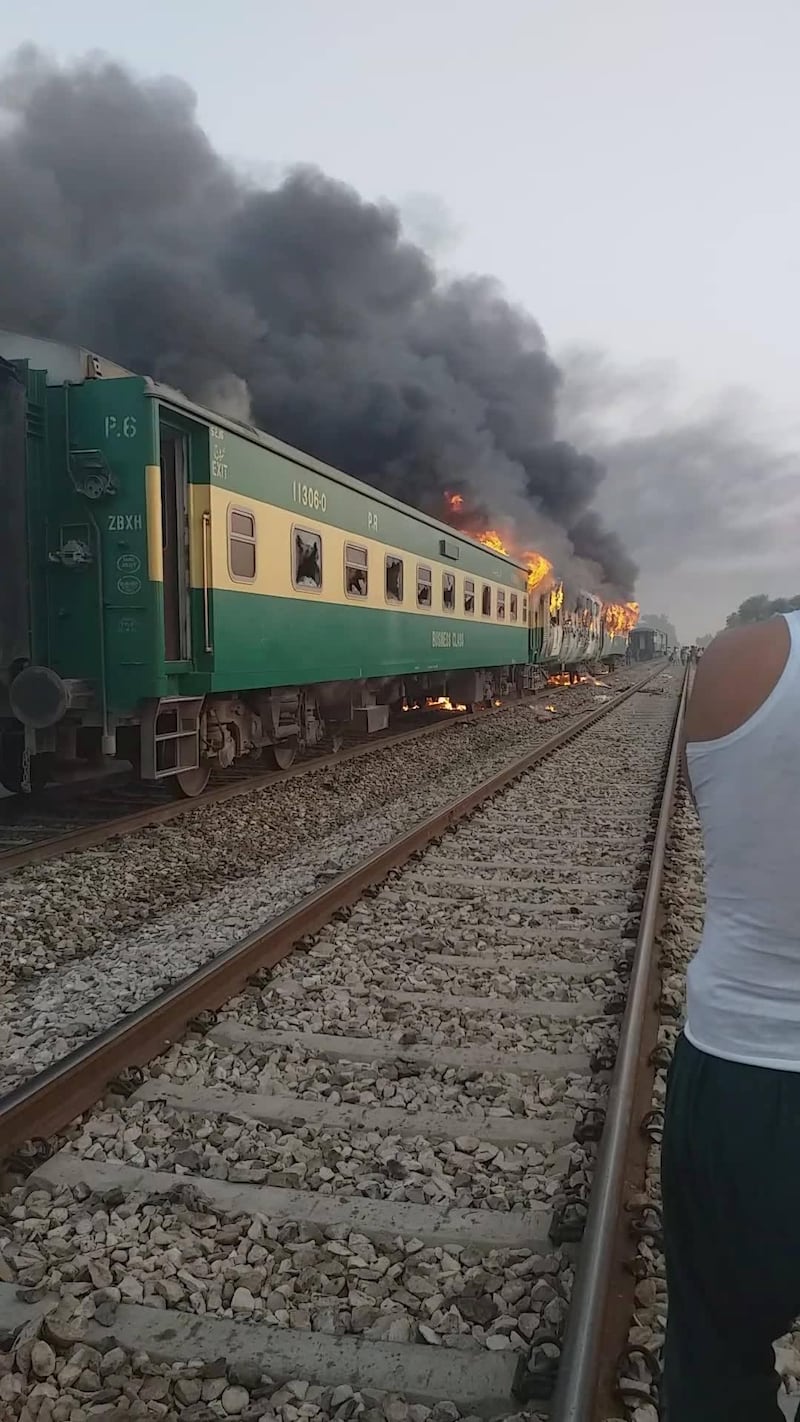 A train burns after a gas canister passengers were using to cook breakfast exploded, near the town of Rahim Yar Khan in the south of Punjab province, Pakistan, in this still image take from video obtained from social media. REUTERS