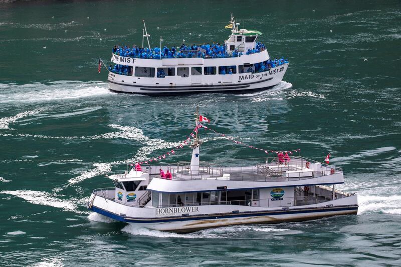 American tourist boat 'Maid of the Mist' glides past a Canadian vessel in Niagara Falls, Ontario, Canada July 21, 2020. Reuters