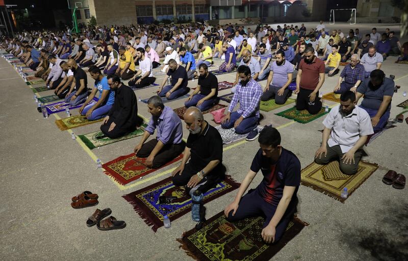 Palestinians pray the Tarawih (extended night prayers) in Jenin school in the West Bank city of Jenin.  EPA