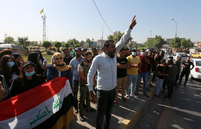 epa08762554 Iraqi unemployed graduates chant slogans during a demonstration near the green zone in central Baghdad, Iraq, 21 October 2020. Dozens of Iraqi graduates were wounded when Iraqi anti-riot police forces broke up their open sit-in front of the gates of green zone, which houses the headquarters of Iraqi government in central Baghdad.  EPA-EFE/AHMED JALIL *** Local Caption *** 56438579