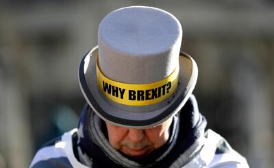 Why Brexit? written on the hat of Anti-Brexit campaigner Steve Bray as he stands outside Parliament in London, Wednesday, Jan. 29, 2020. Britain officially leaves the European Union on Friday after a debilitating political period that has bitterly divided the nation since the 2016 Brexit referendum. (AP Photo/Kirsty Wigglesworth)