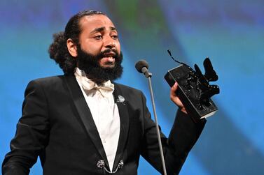 Ismael El Iraki recieves the Orizzonti Award for Best Actress on behalf of Moroccan singer and actress Khansa Batma, for 'Zanka Contact' during the 77th Venice Film Festival. AFP 