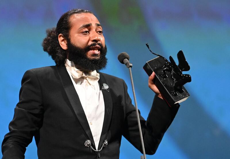 Moroccan French director Ismael El Iraki acknowledges receiving the Orizzonti Award for Best Actress on behalf of Moroccan singer and actress Khansa Batma, for "Zanka Contact" during the closing ceremony on the last day of the 77th Venice Film Festival, on September 12, 2020 at Venice Lido, during the COVID-19 infection, caused by the novel coronavirus.  / AFP / Alberto PIZZOLI
