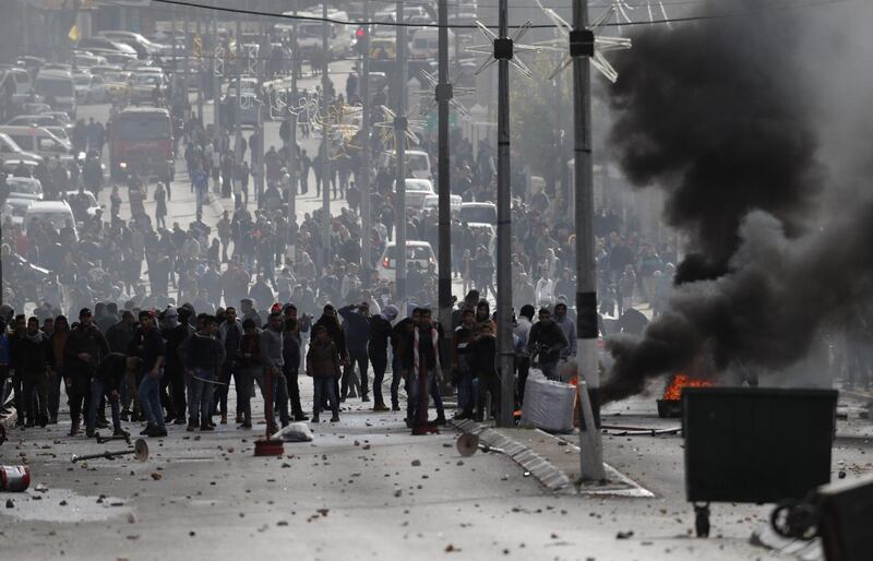 Palestinian protesters clash with Israeli forces near an Israeli checkpoint in Bethelem on December 7, 2017. Thomas Coex / AFP