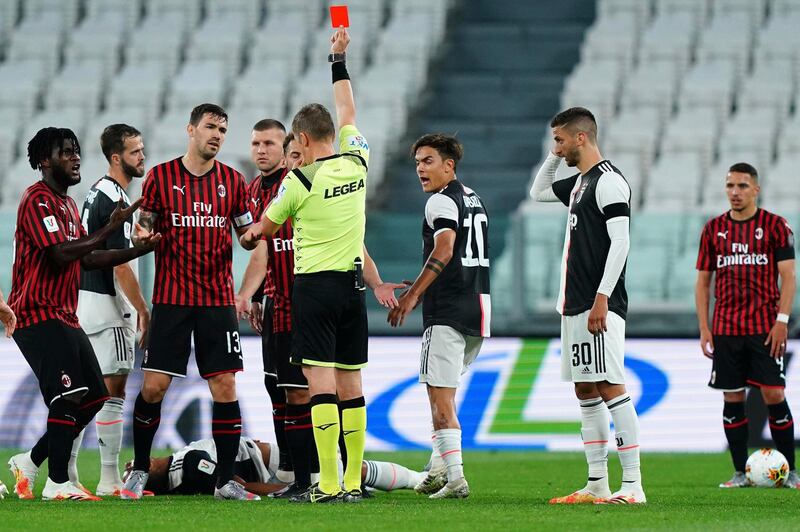 Referee Daniele Orsato shows a red card to AC Milan's Ante Rebic (4th from left) during the Italian Cup second leg match against Juventus. AP