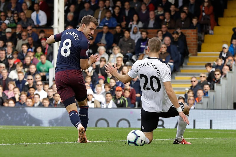 Arsenal's Aaron Ramsey, left, scores his side's third goal during the English Premier League soccer match between Fulham and Arsenal at Craven Cottage stadium in London, Sunday, Oct. 7, 2018. (AP Photo/Kirsty Wigglesworth)