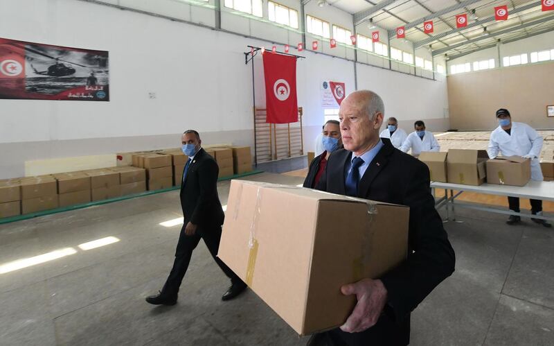 President Kais Saied taking part in the distribution of aid packages amid the coronavirus pandemic, in Gammarth town on the outskirts of Tunis. AFP
