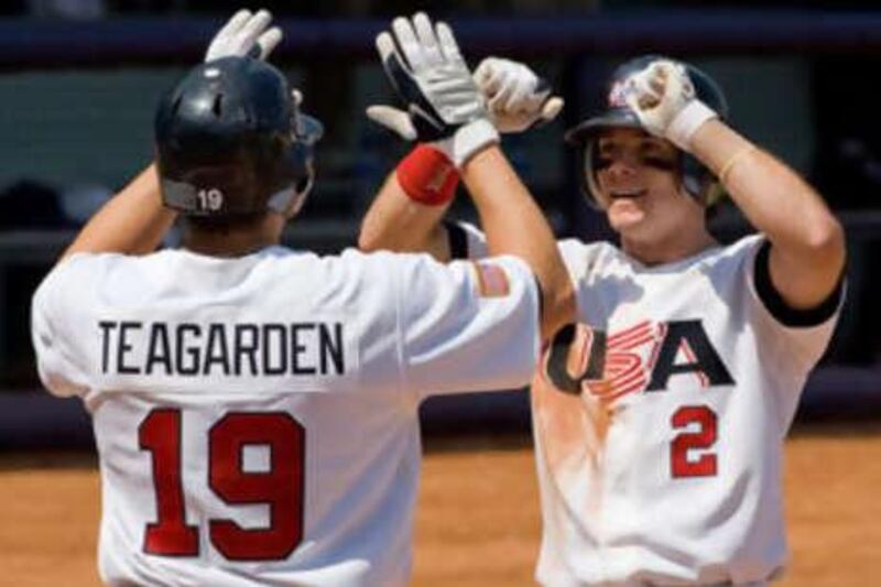 The US shortstop Jason Donald, right, celebrates with teammate Taylor Teagarden after his three-run homerun against Japan.